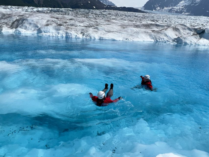 Anchorage: Knik Glacier Helicopter and Paddleboarding Tour - Learning to paddle on a glacier pool