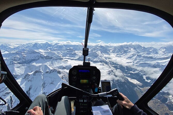 Private Swiss Alps helicopter tour over snow covered mountain peaks and glaciers - Lake Brienz and steep mountain walls